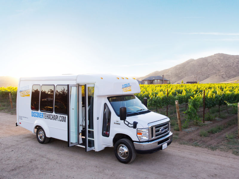Discover Tehachapi bus in front of vineyard